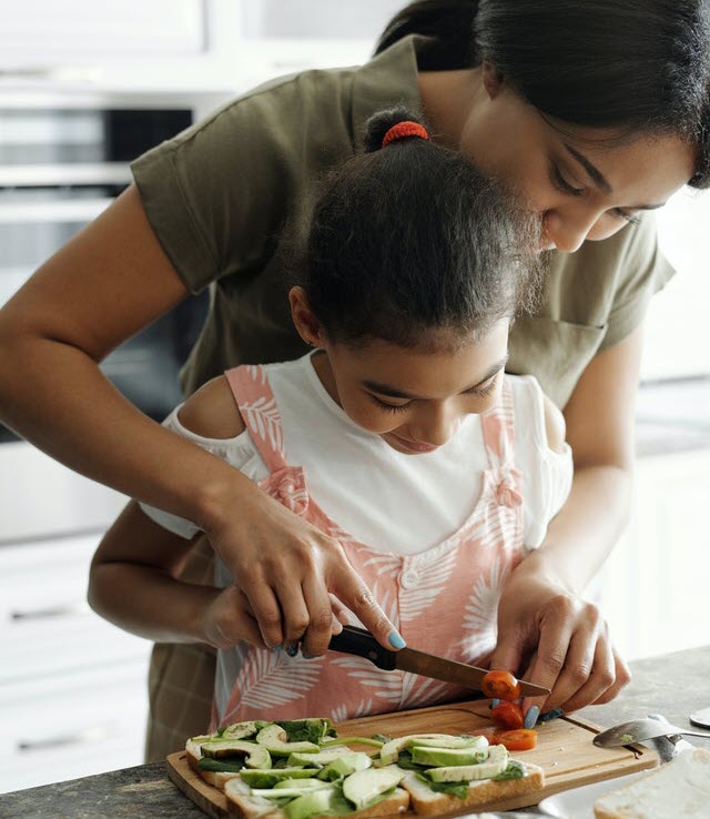 Woman and child preparing vegetables